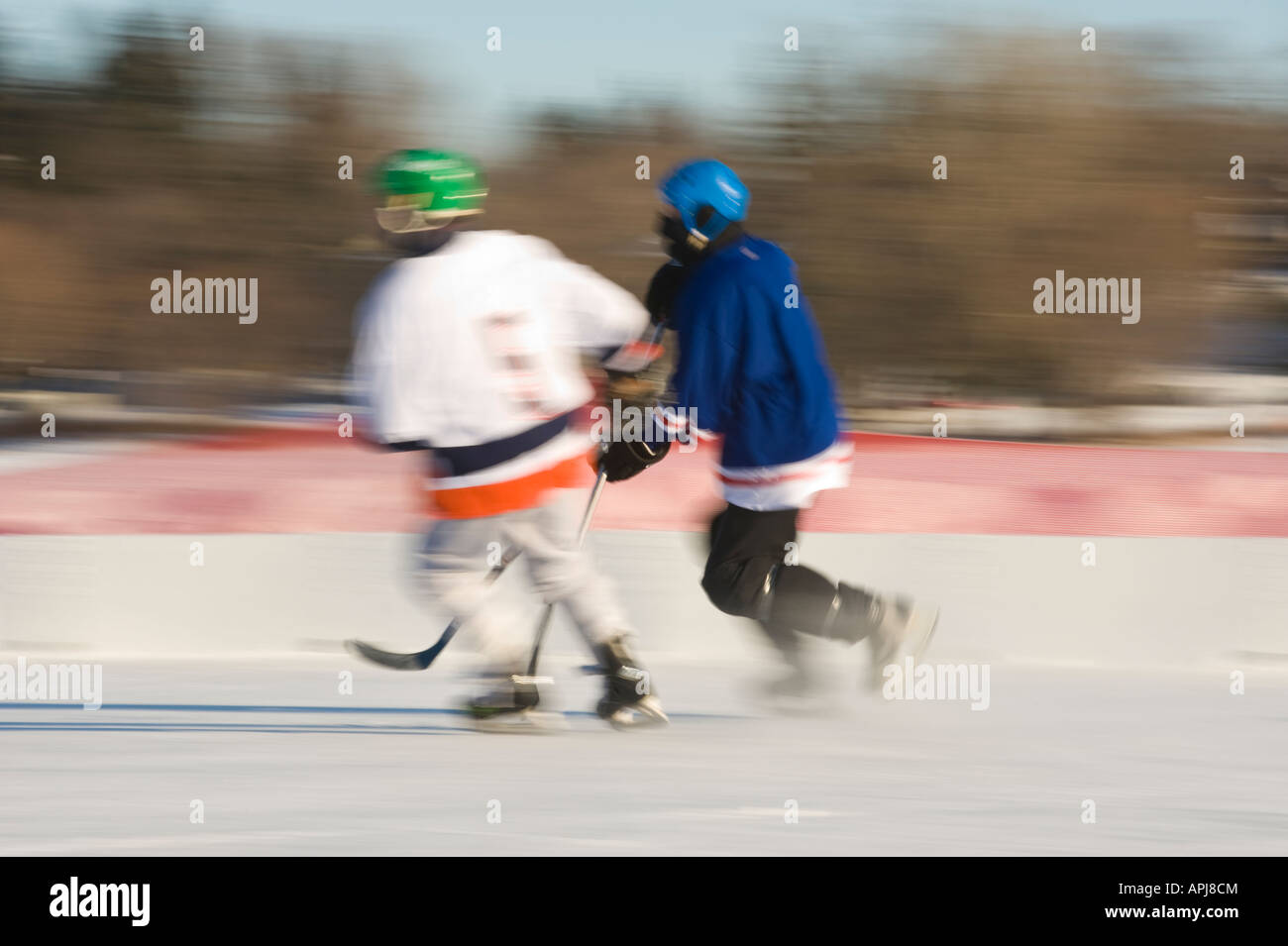 TWO HOCKEY PLAYERS SPEED DOWN THE RINK US POND HOCKEY CHAMPIONSHIPS
