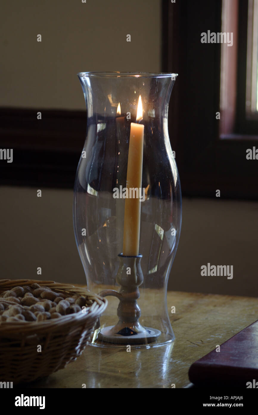 Candle in a glass chimney on a table Stock Photo Alamy