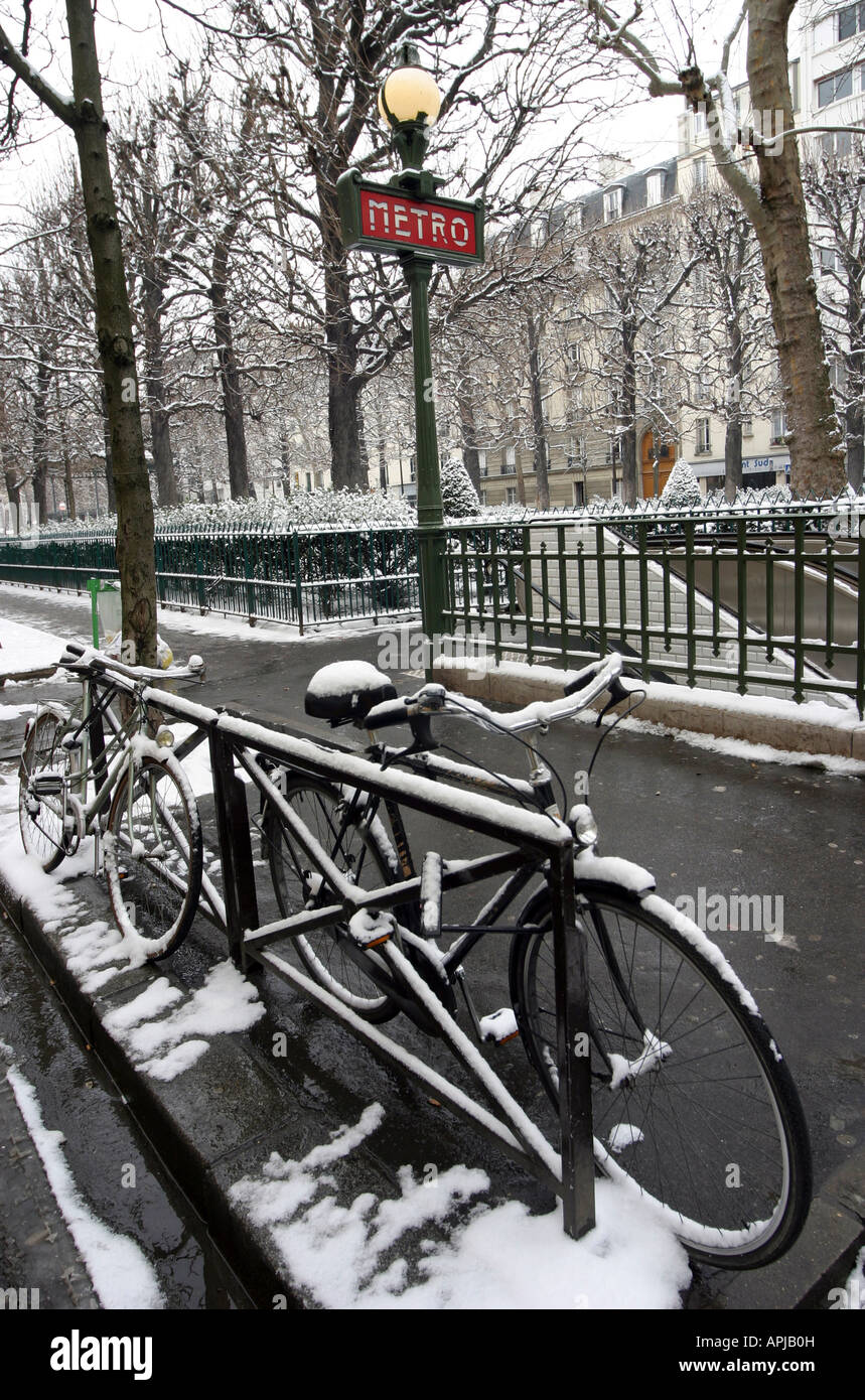 Bicycles in the snow outside the metro station Commerce Paris 15e France Stock Photo