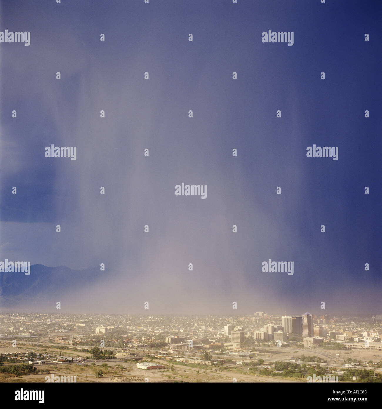 A summer monsoon storm produces a deluge of rain water onto the city of Tucson Arizona USA as seen from atop A Mountain. Stock Photo