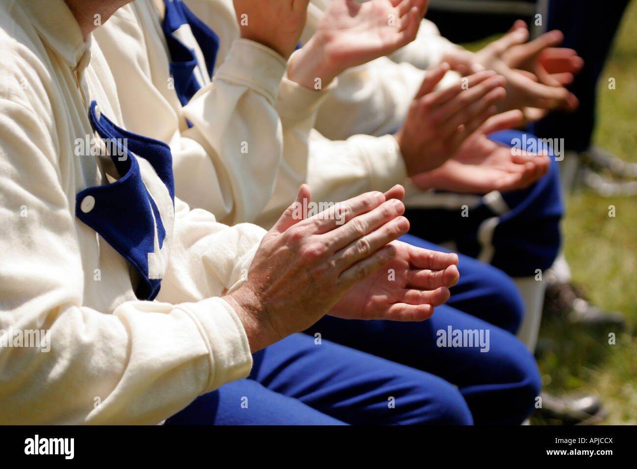Baseball players clapping and cheering at a vintage baseball game being