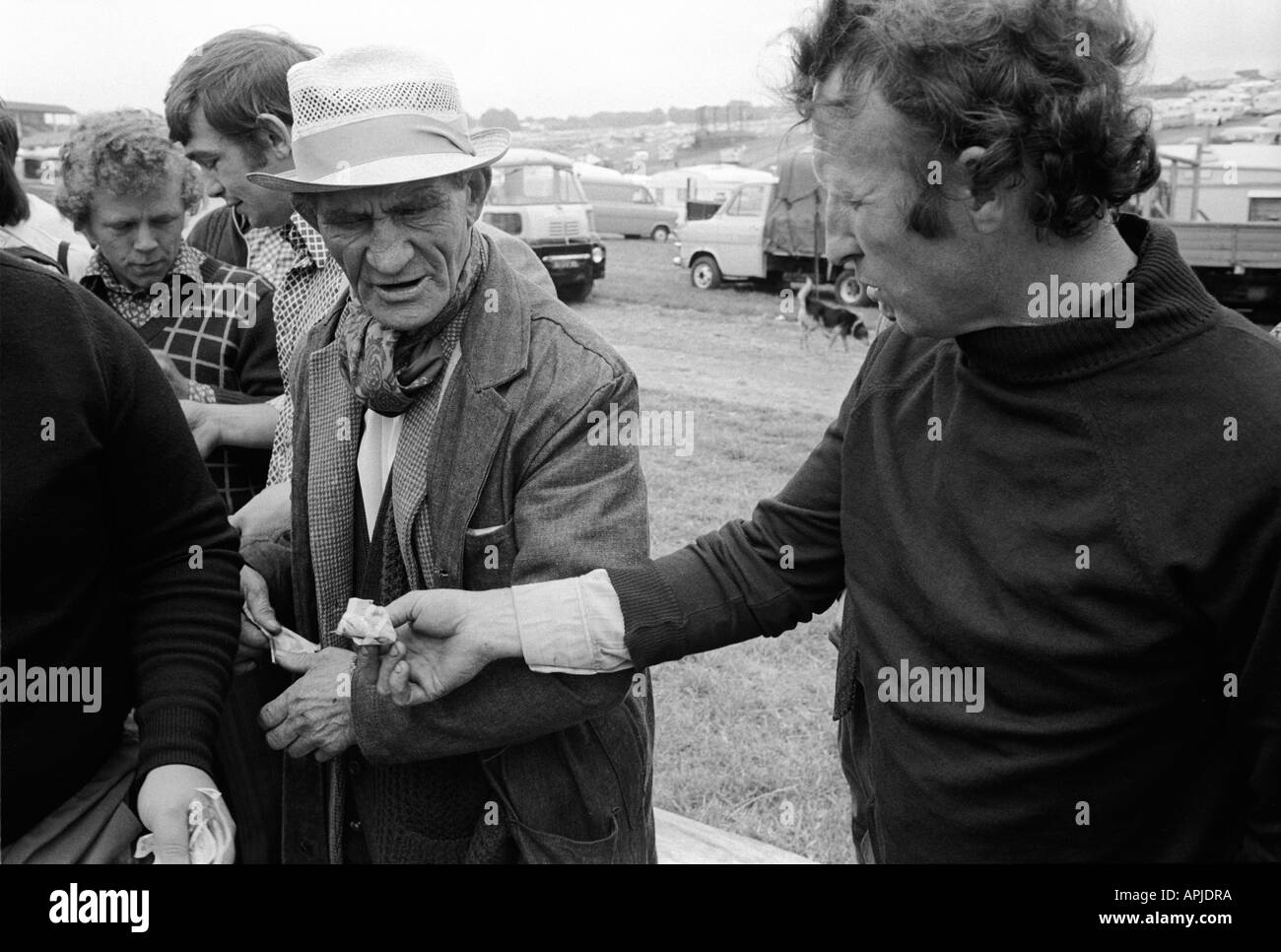 Money changing hands  a payment Gypsies at the  Derby Day horse race Epsom Downs Surrey England 1974. Illegal gambling. 1970s UK HOMER SYKES Stock Photo