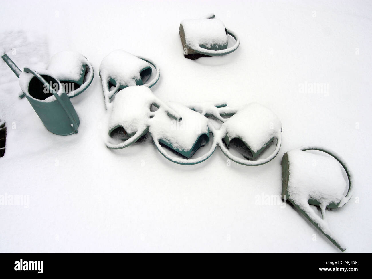 Watering cans in the snow Grenelle Cemetery rue St Charles Paris 15th France Stock Photo