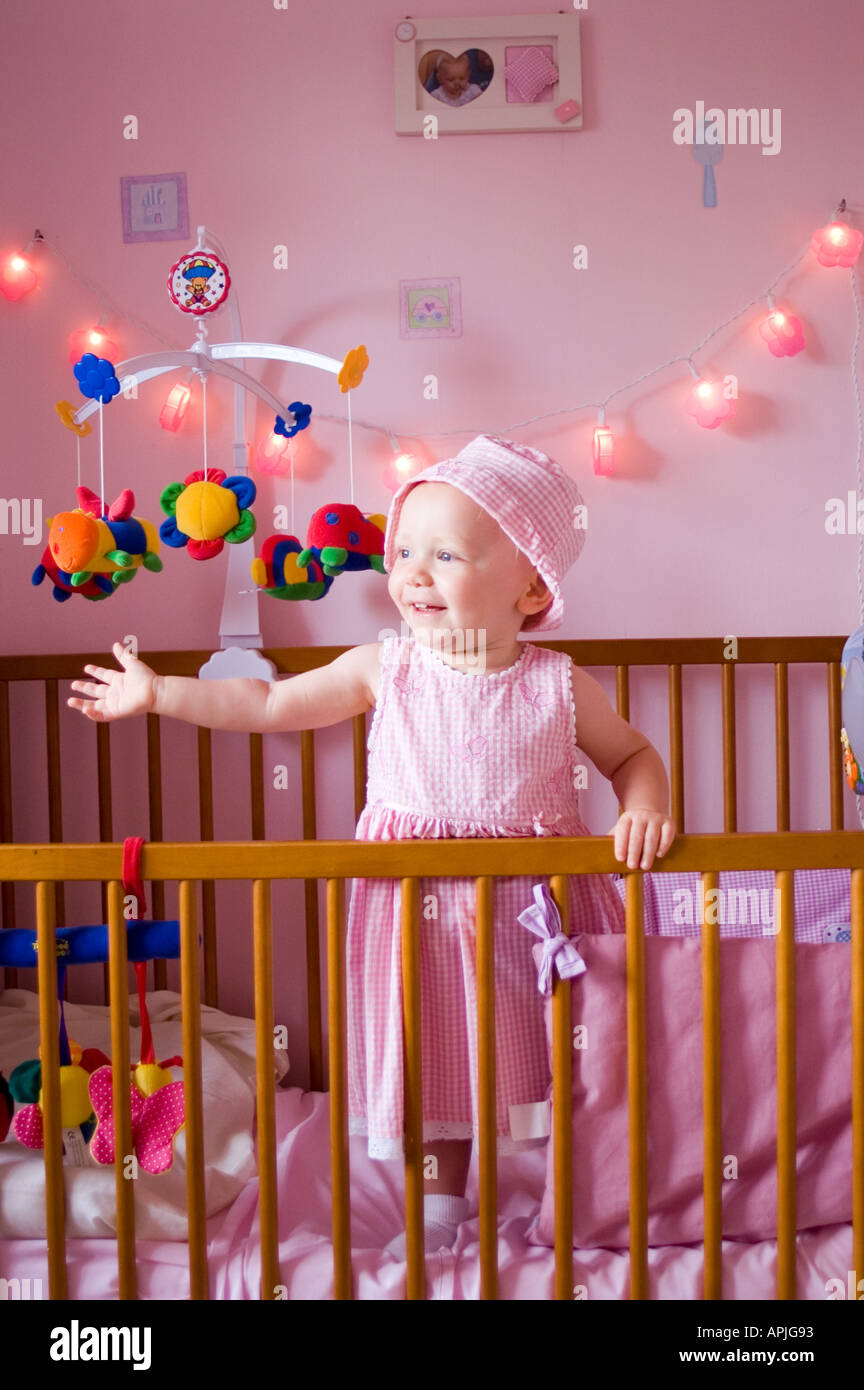 Baby in cot and bedroom Stock Photo Alamy