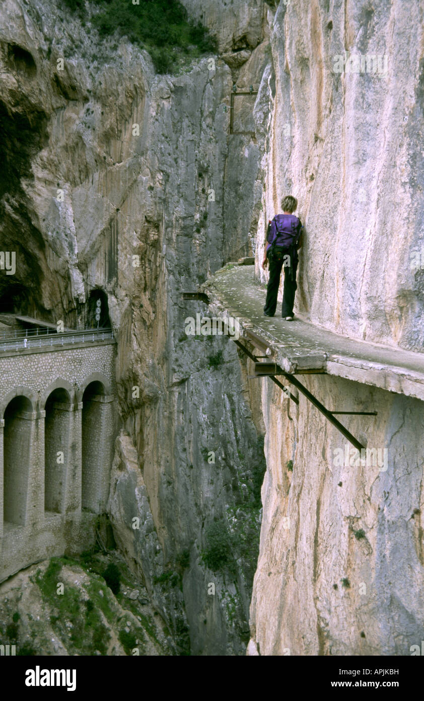 A hiker on an exposed section of the Camino del Rey In El Chorro Canyon, Andalusia, Spain Stock Photo