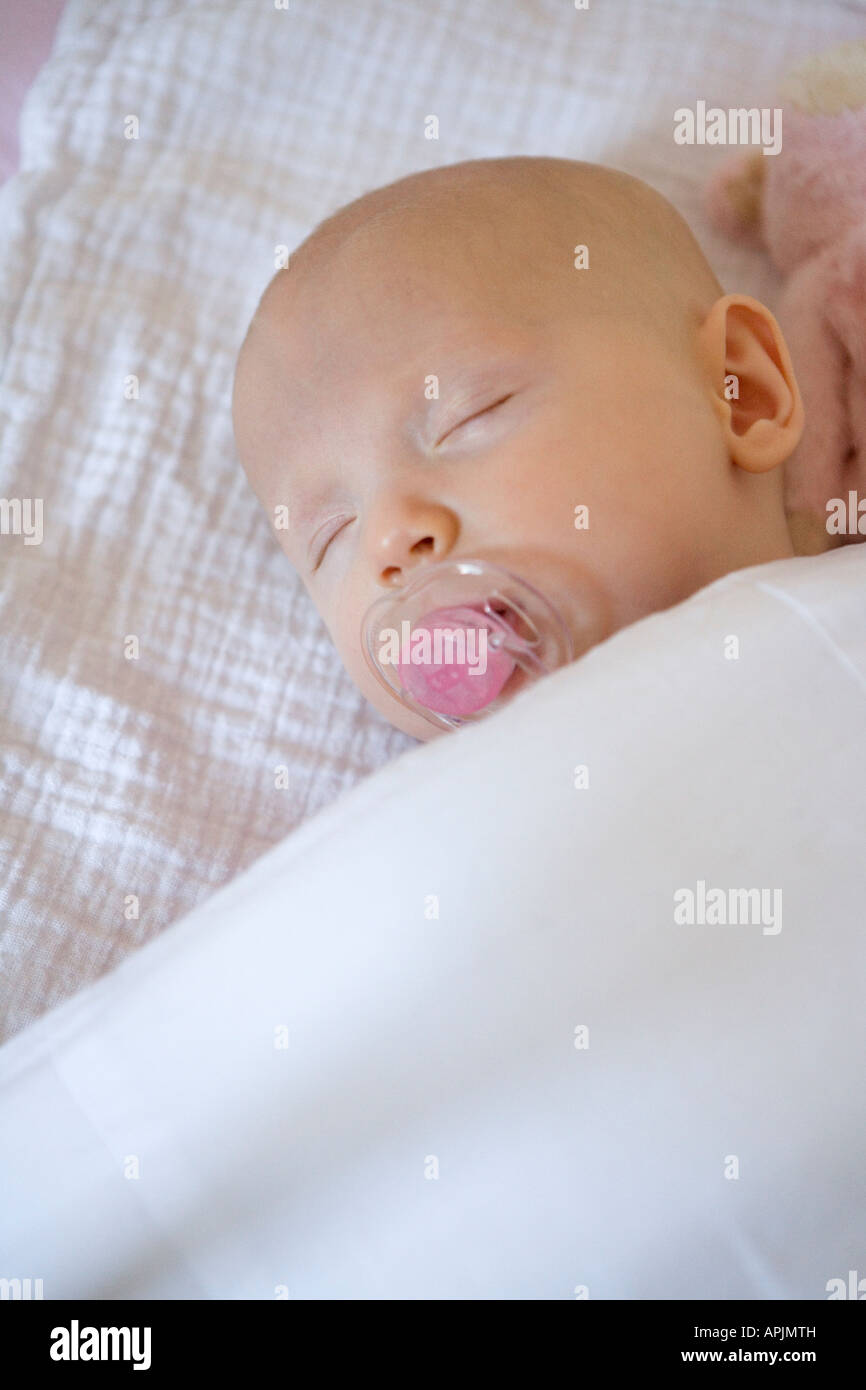 Sleeping baby with a comforter Stock Photo Alamy