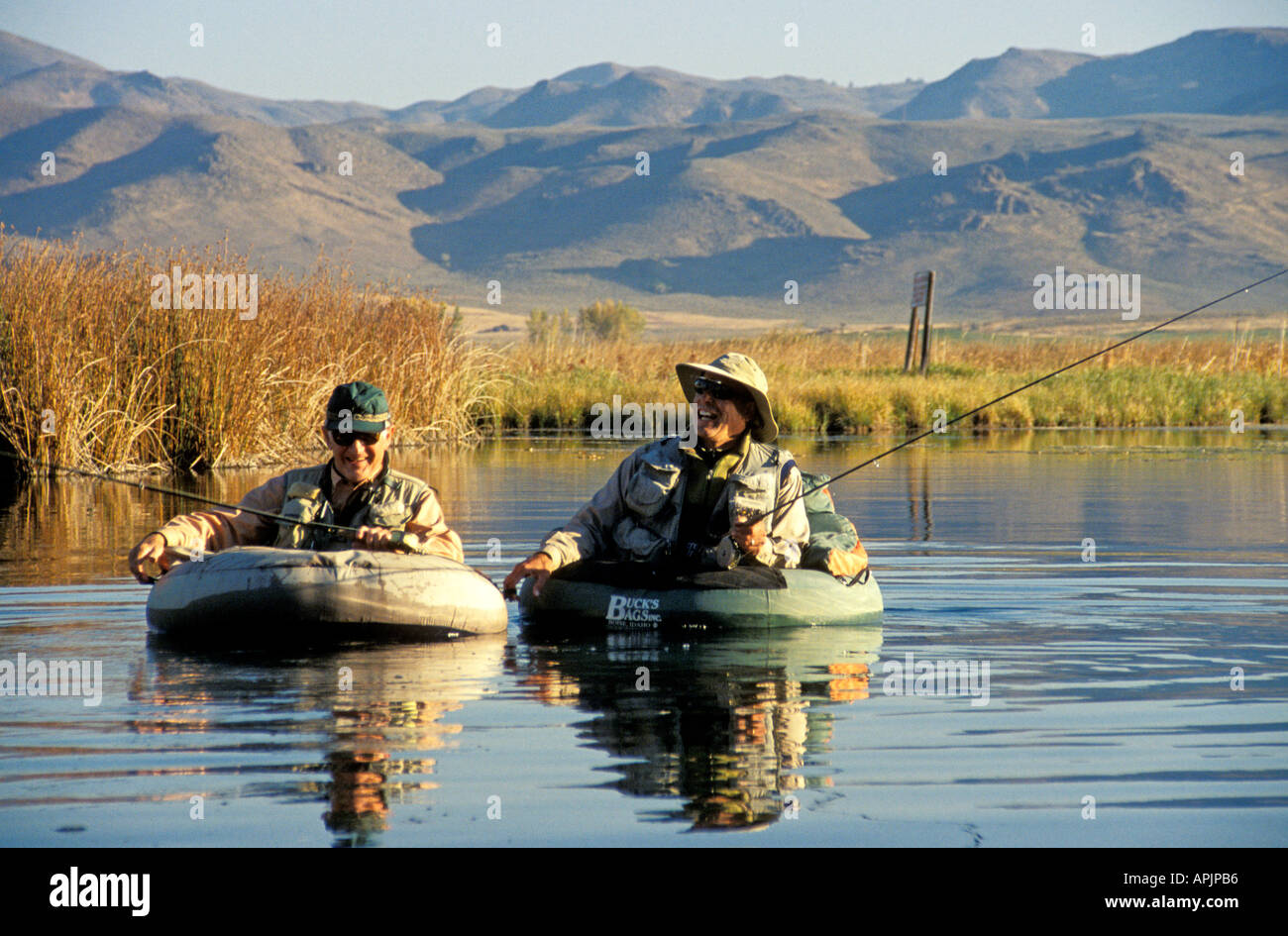 Idaho Silver Creek near Sun Valley two men in float tubes smile