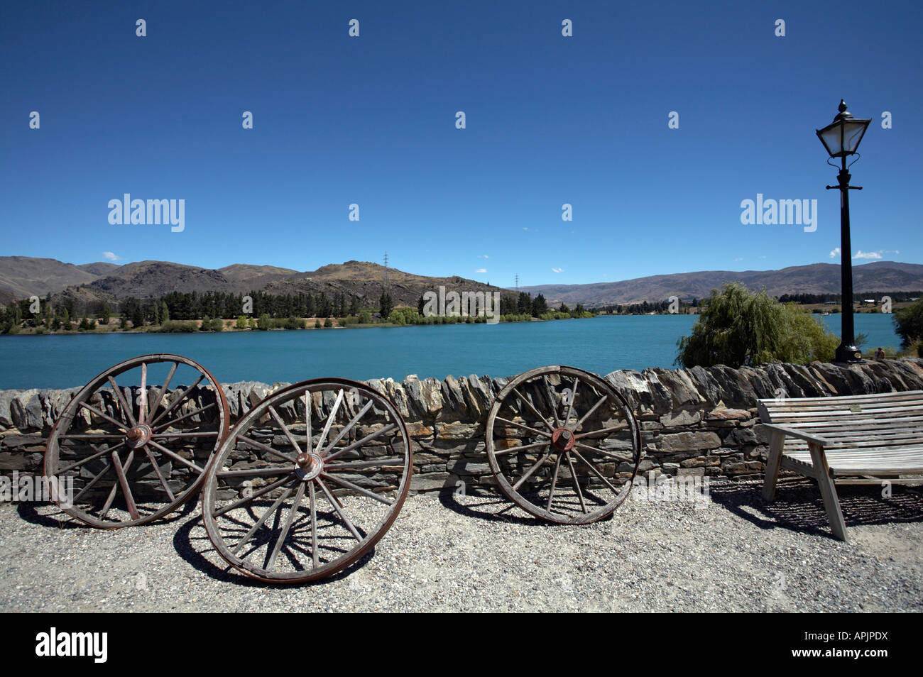 Wagon wheels leant against the wall by Lake Dunstan, Old Cromwell Town