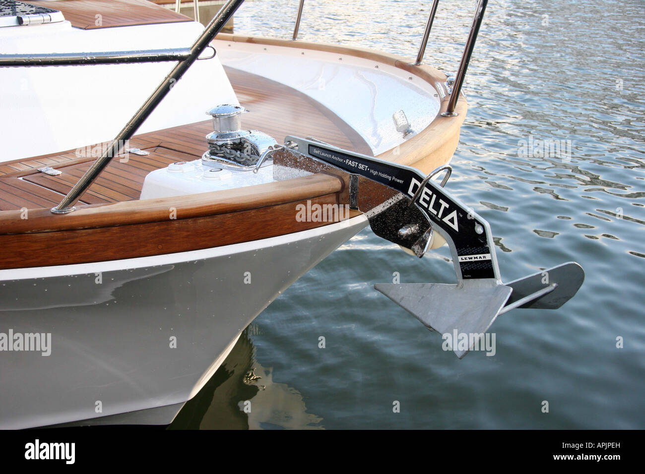 Delta anchor on the front of a boat with wooden decks Stock Photo Alamy