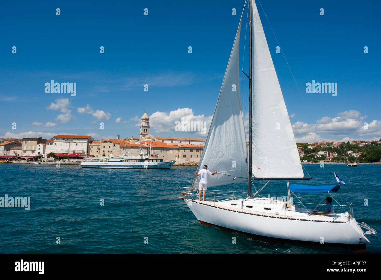 Sail boat entering port, Krk on Krk island in Croatia, Europe Stock Photo