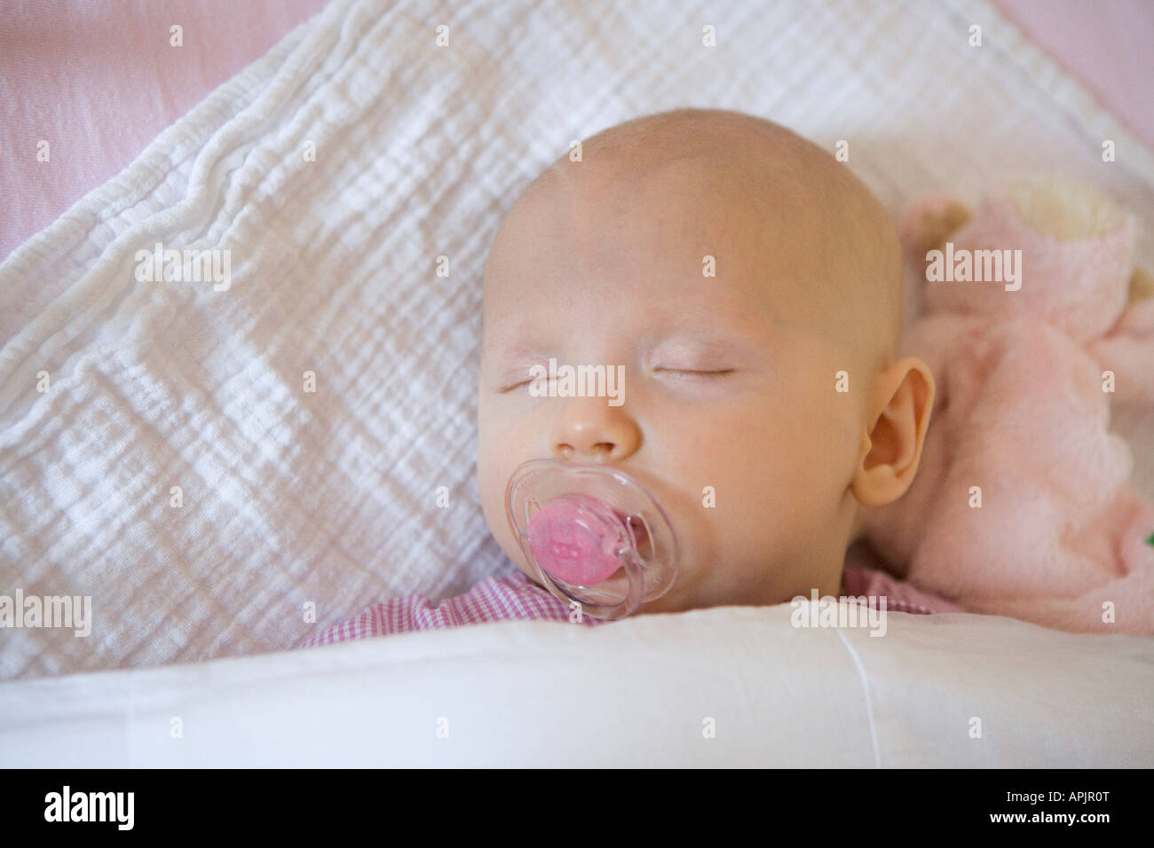 Sleeping baby with a comforter Stock Photo Alamy