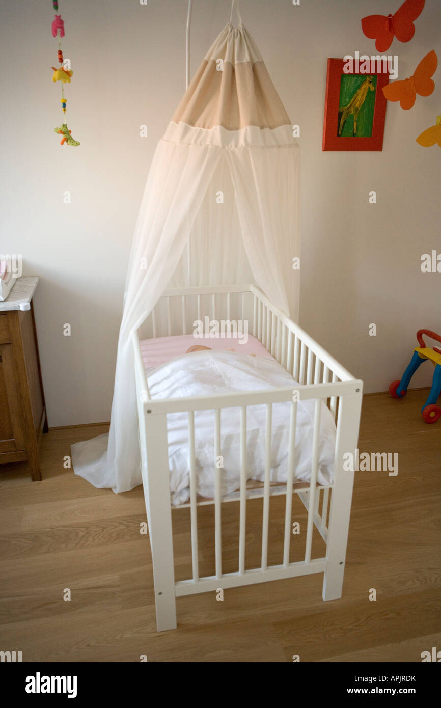 Sleeping baby in a cot Stock Photo Alamy