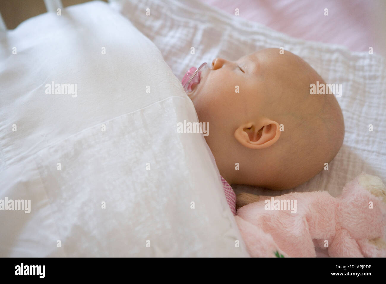 Sleeping baby with a comforter Stock Photo Alamy