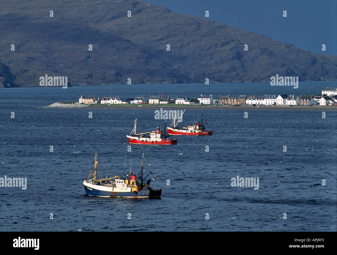 FISHING BOATS AT ANCHOR IN BAY SHELTERING FROM BAD WEATHER AT LOCH
