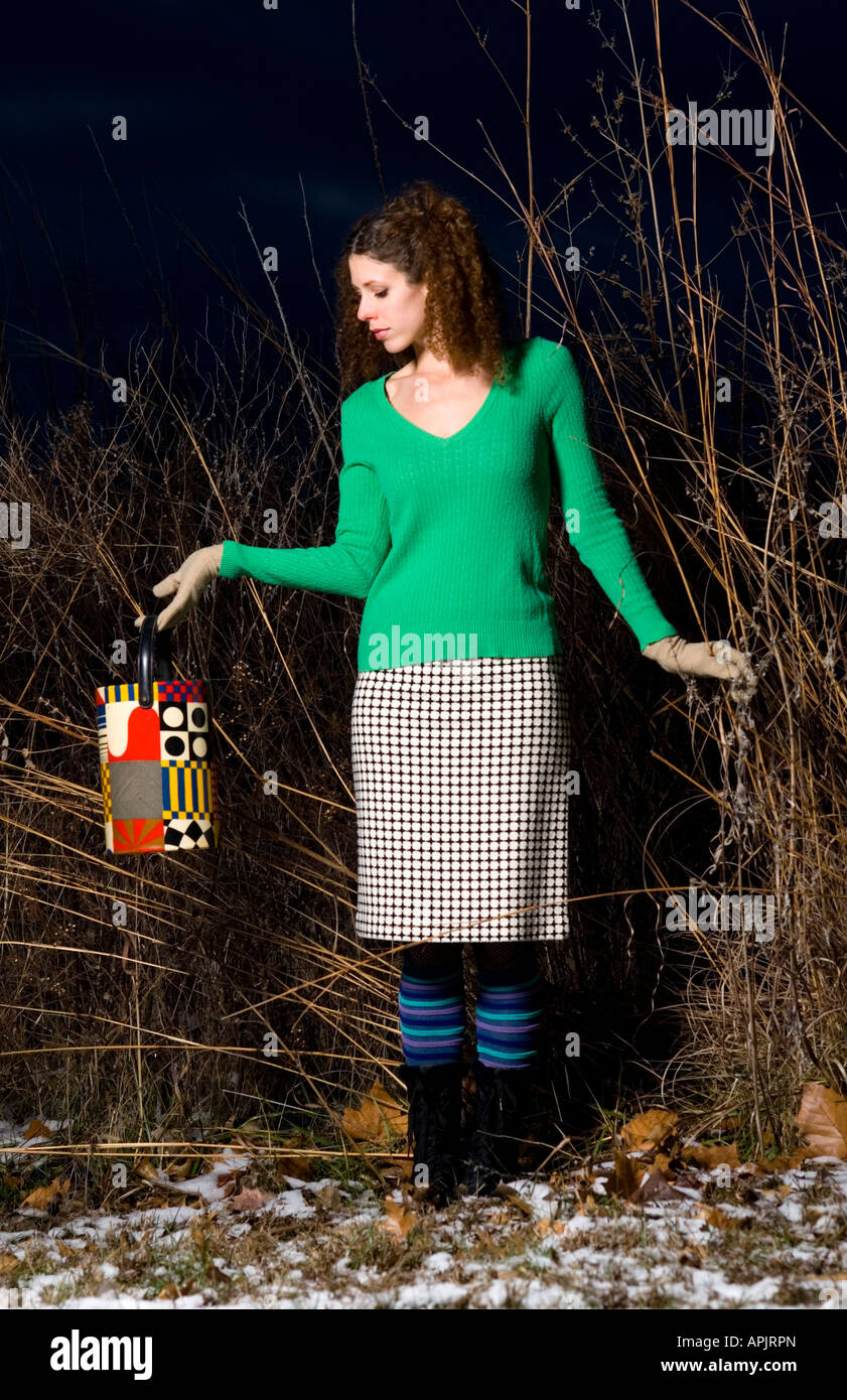 attractive young fashion model outdoors at dusk Stock Photo