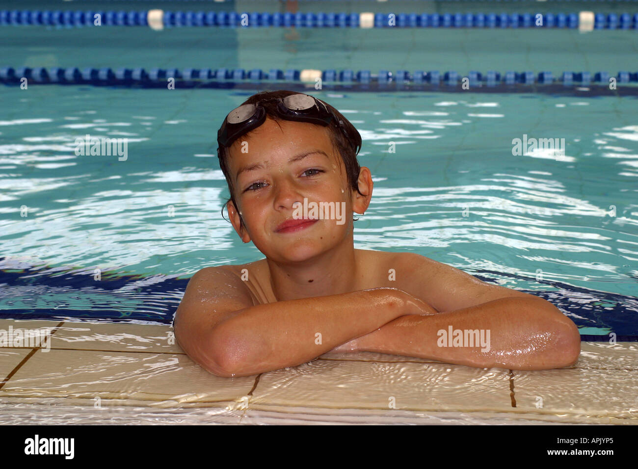 Young boy relaxing in a swimming pool Stock Photo - Alamy