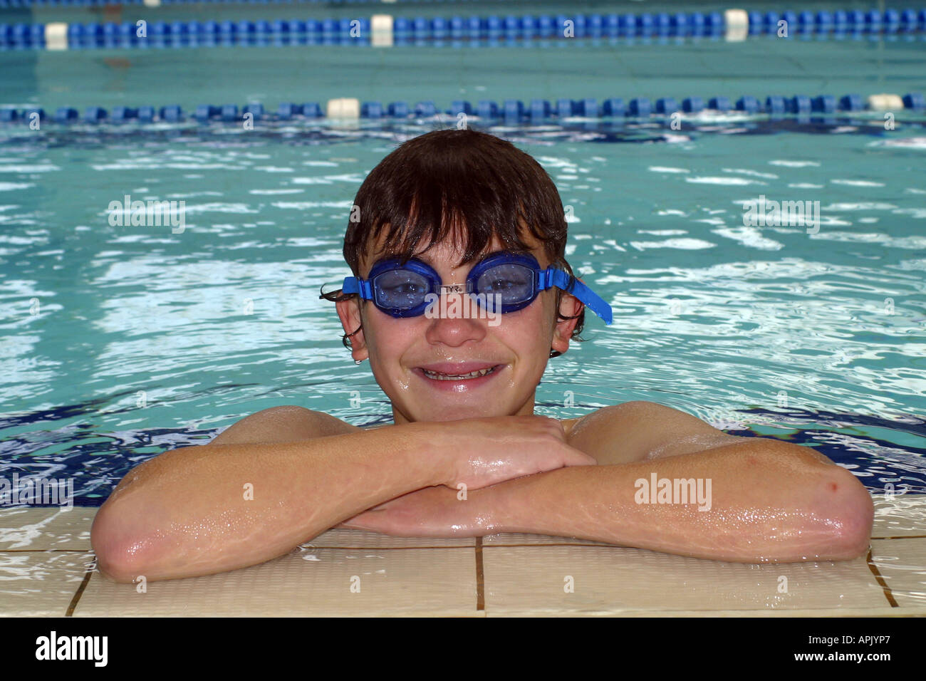 Young boy relaxing in a swimming pool Stock Photo - Alamy