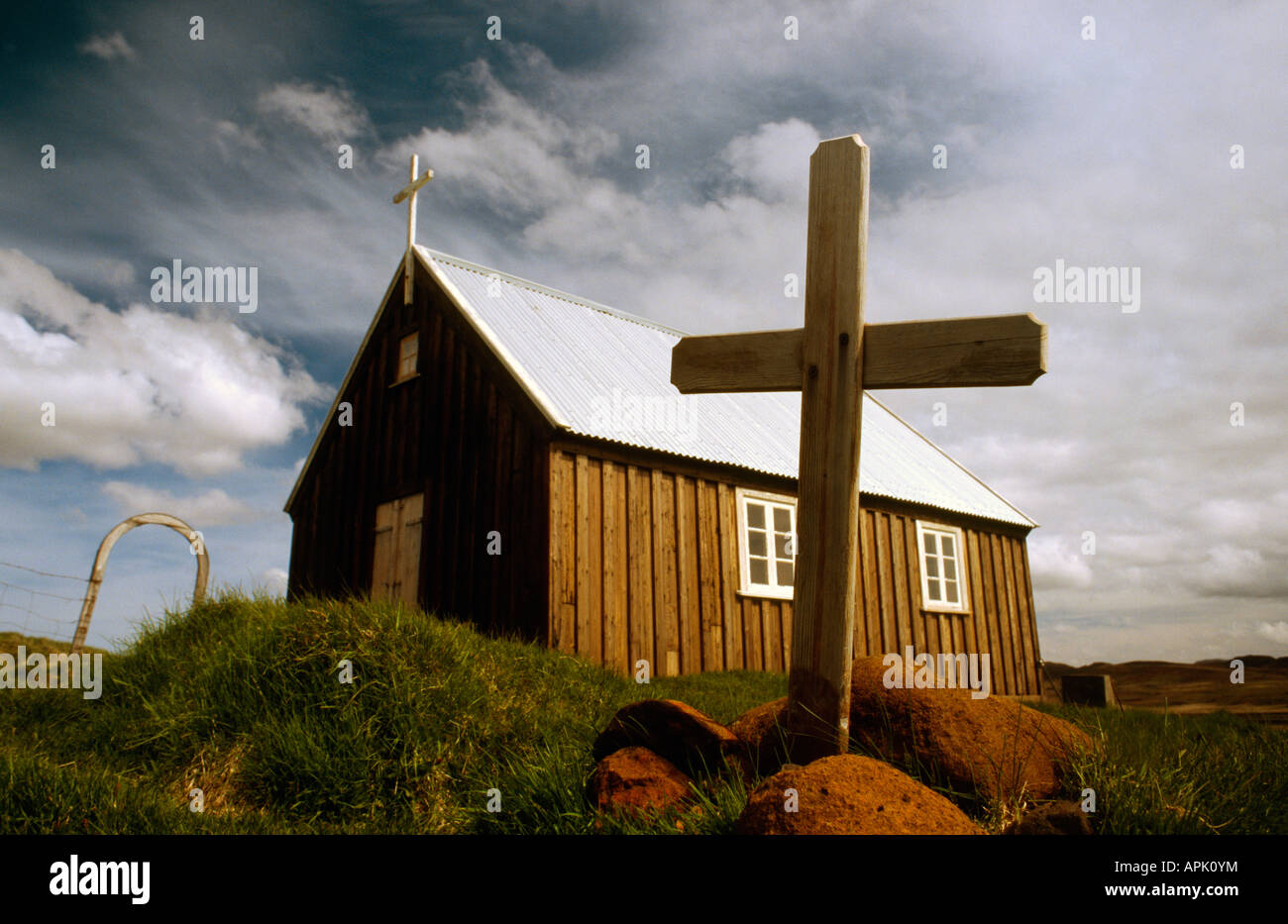 PICTURE CREDIT DOUG BLANE Cross small Church perched on the edge of a lava plain at Krysuvik Iceland Stock Photo