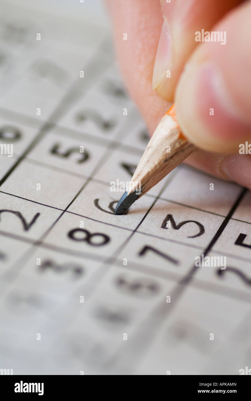 Completing Sudoku puzzle with pencil Stock Photo Alamy