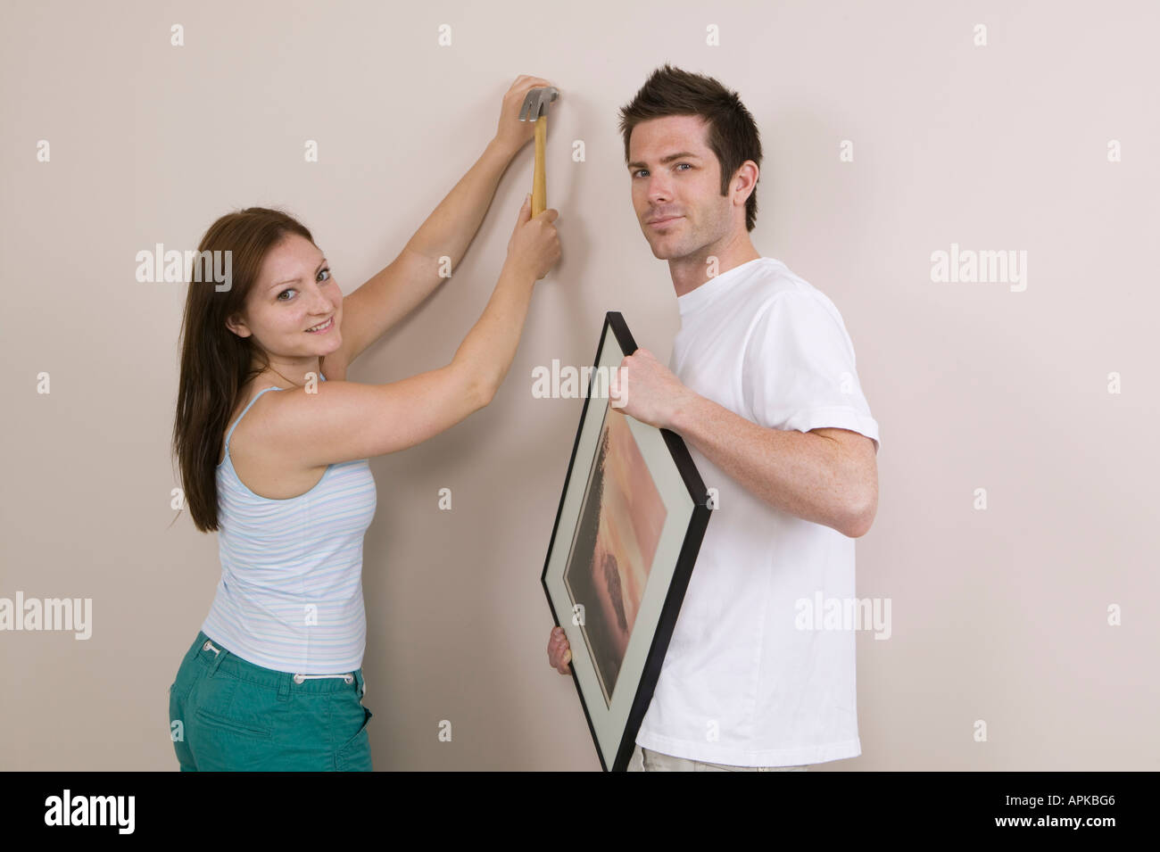 Couple Hanging a Picture Stock Photo