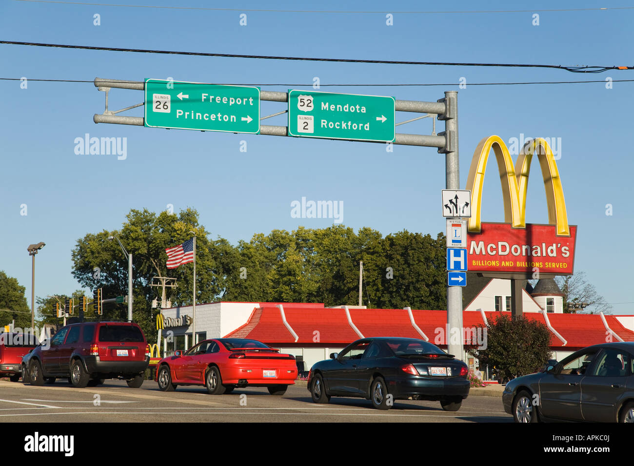 ILLINOIS Dixon Lincoln Highway sign McDonalds restaurant and traffic highway intersection information signs vehicles on road Stock Photo