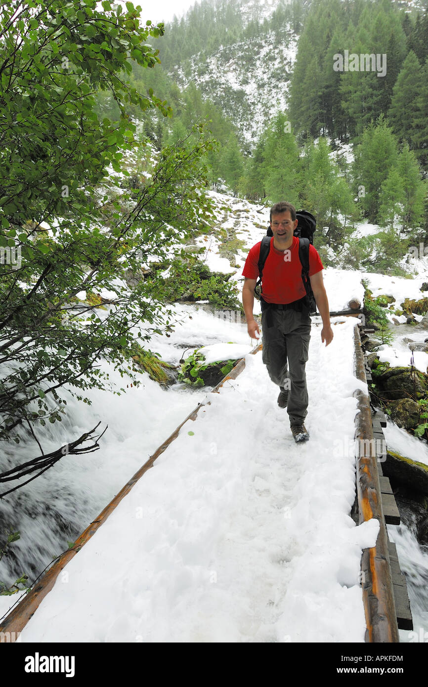 walker on a snowy brigde, Schladminger Tauern, Niedere Tauern, Austria, Styria, Alps Stock Photo