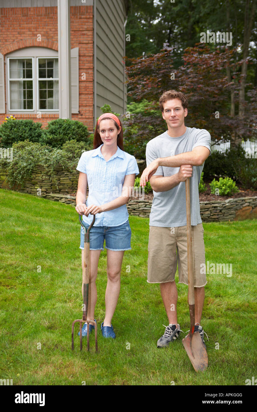Young couple with garden fork and spade Stock Photo