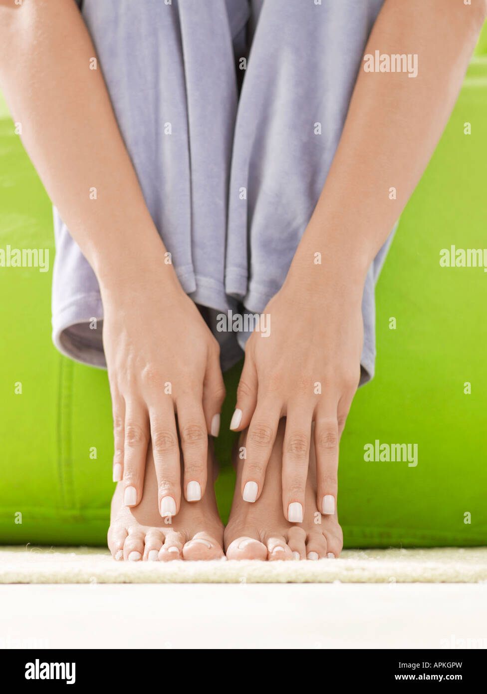 Hands on bare feet (closeup Stock Photo Alamy
