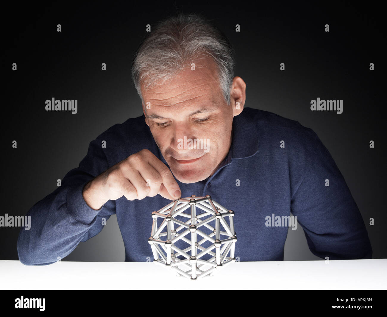 Mature man playing with puzzle Stock Photo