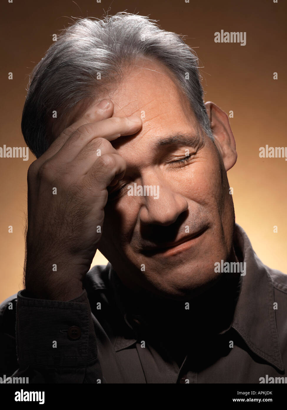 Mature man rubbing forehead Stock Photo Alamy