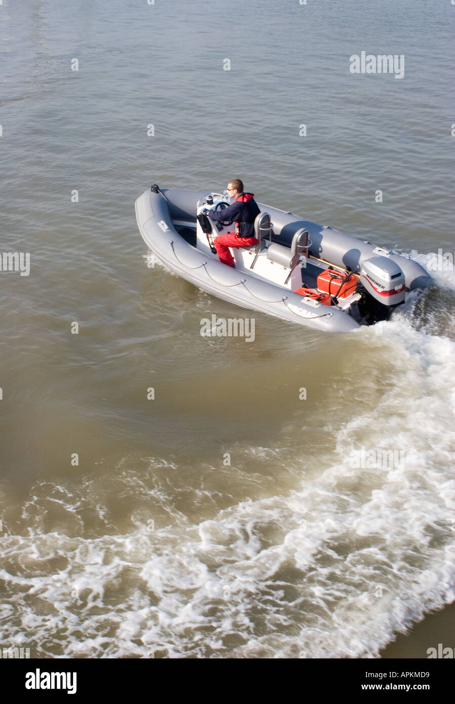 colour image off a speed boat speeding along in the sea lots off waves ...