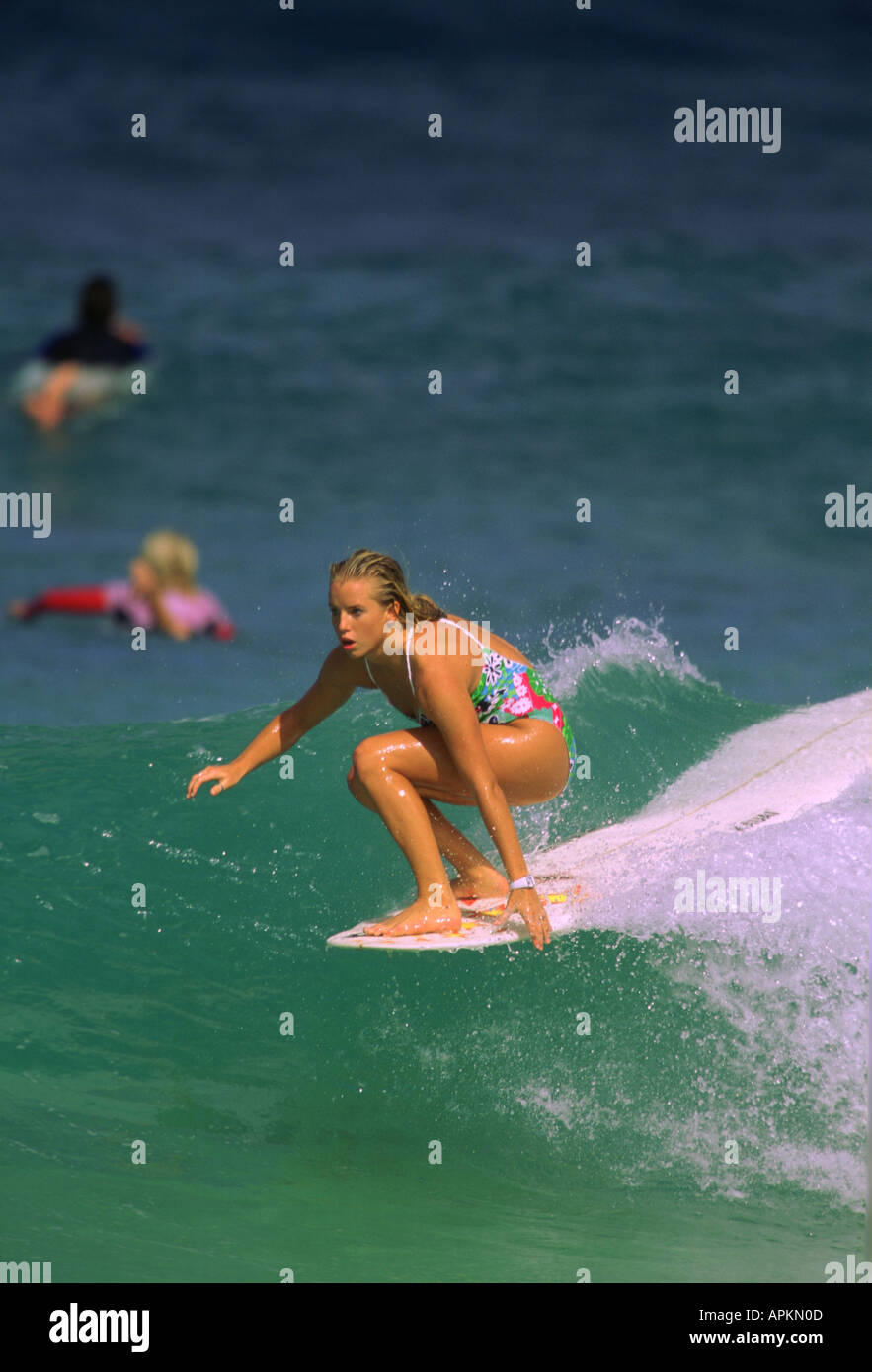 FEMALE SURFING ACTION Stock Photo