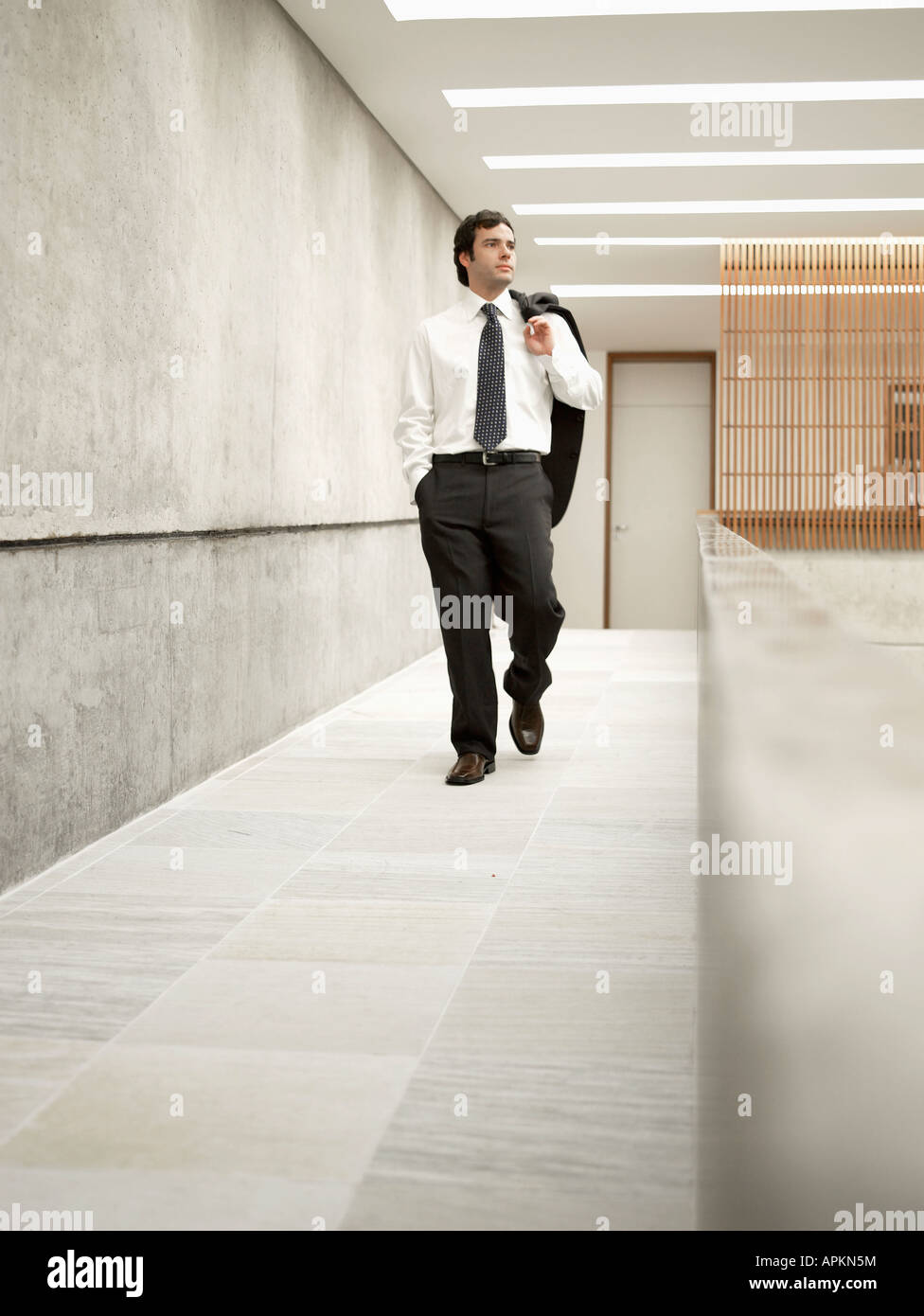 Businessman walking in corridor Stock Photo