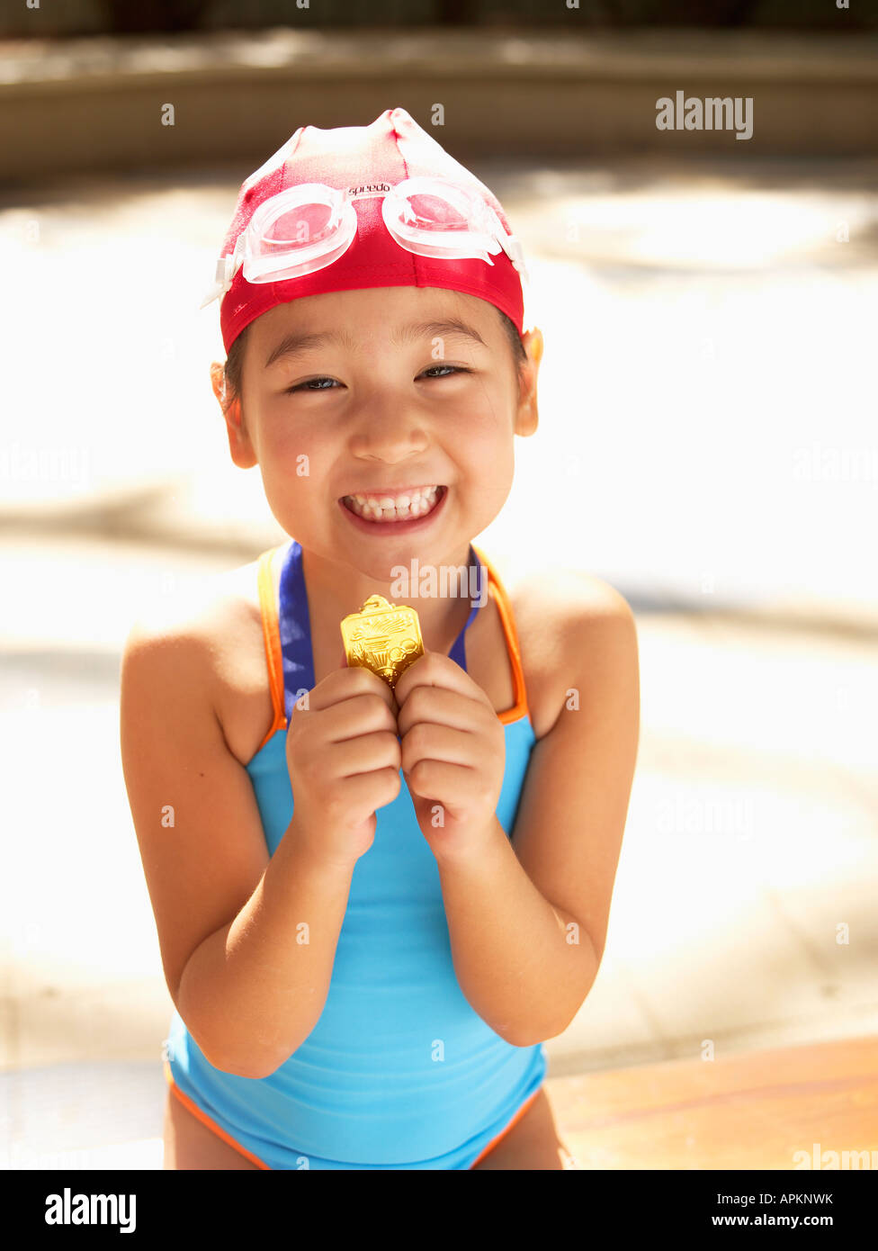 Girl in swimming costume holding first prize (portrait Stock Photo Alamy
