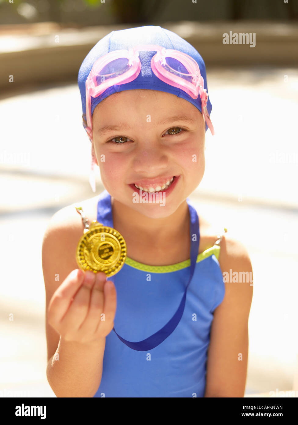 Girl in swimming costume holding medal (portrait Stock Photo Alamy