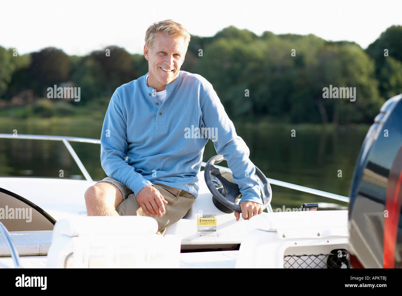 Man sitting in motorboat (portrait Stock Photo - Alamy