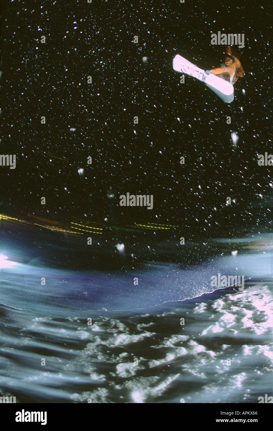 NIGHT TIME SNOWBOARDING ACTION Stock Photo