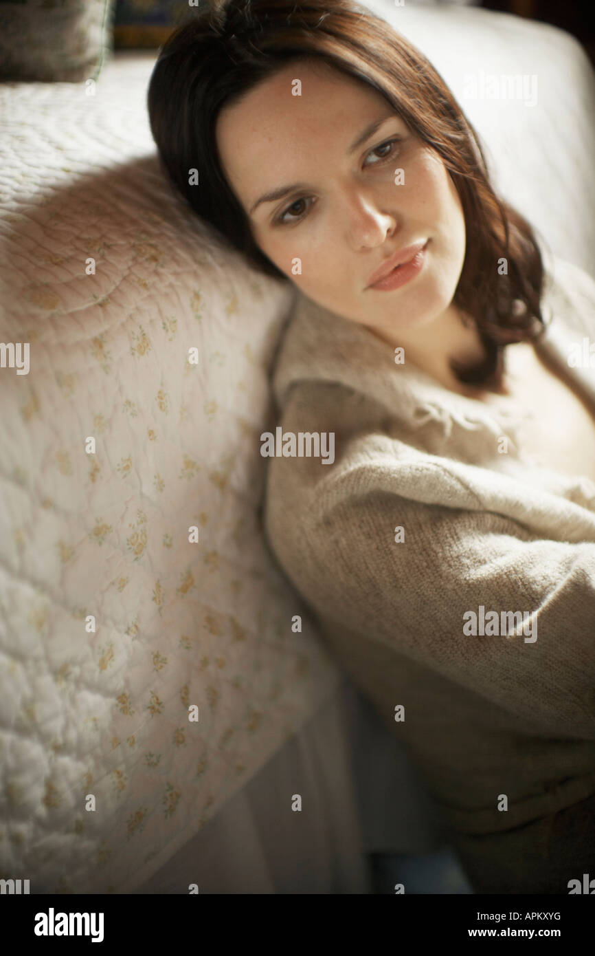 Woman leaning on bed Stock Photo Alamy