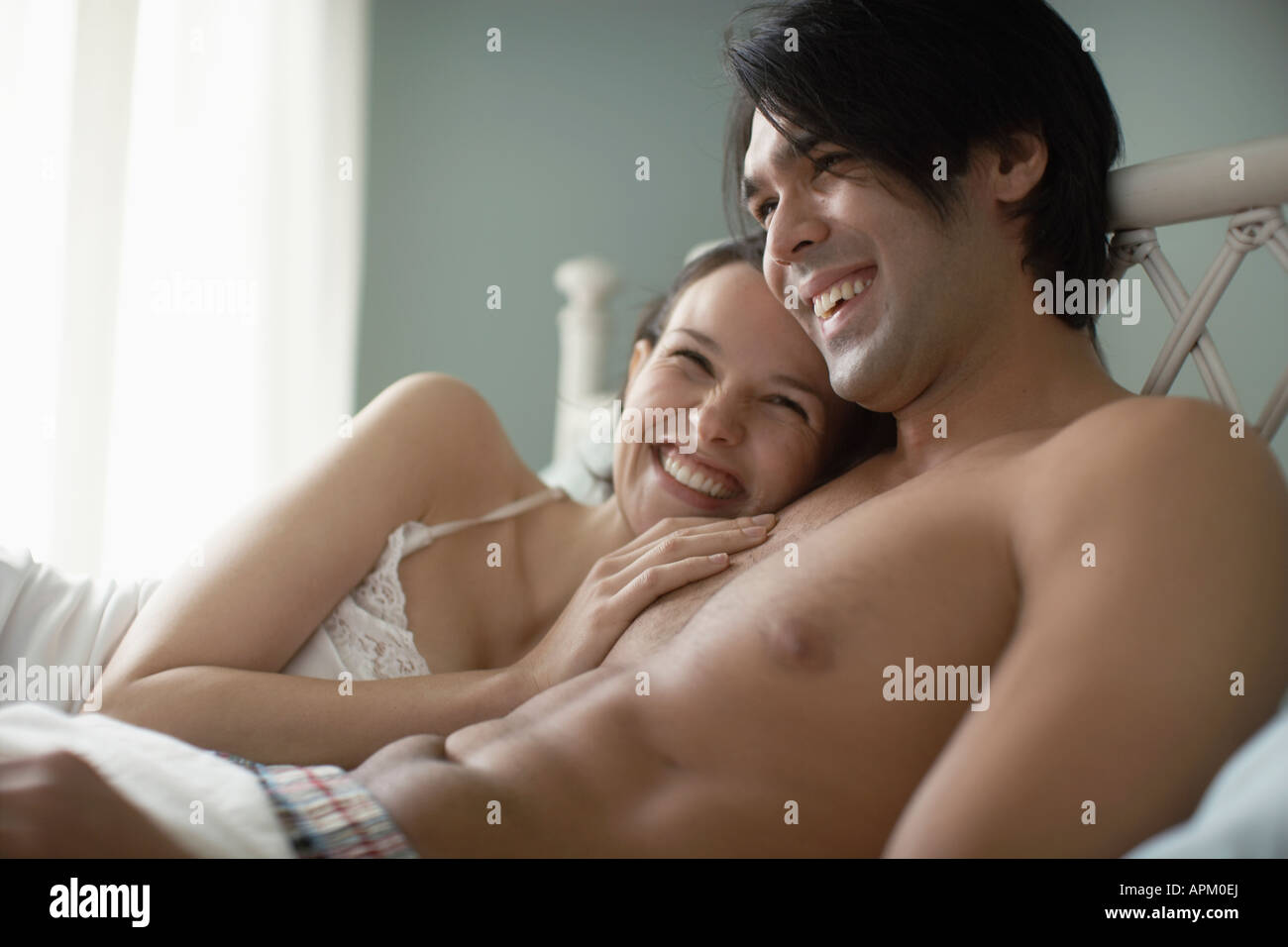 Young couple lying on bed Stock Photo