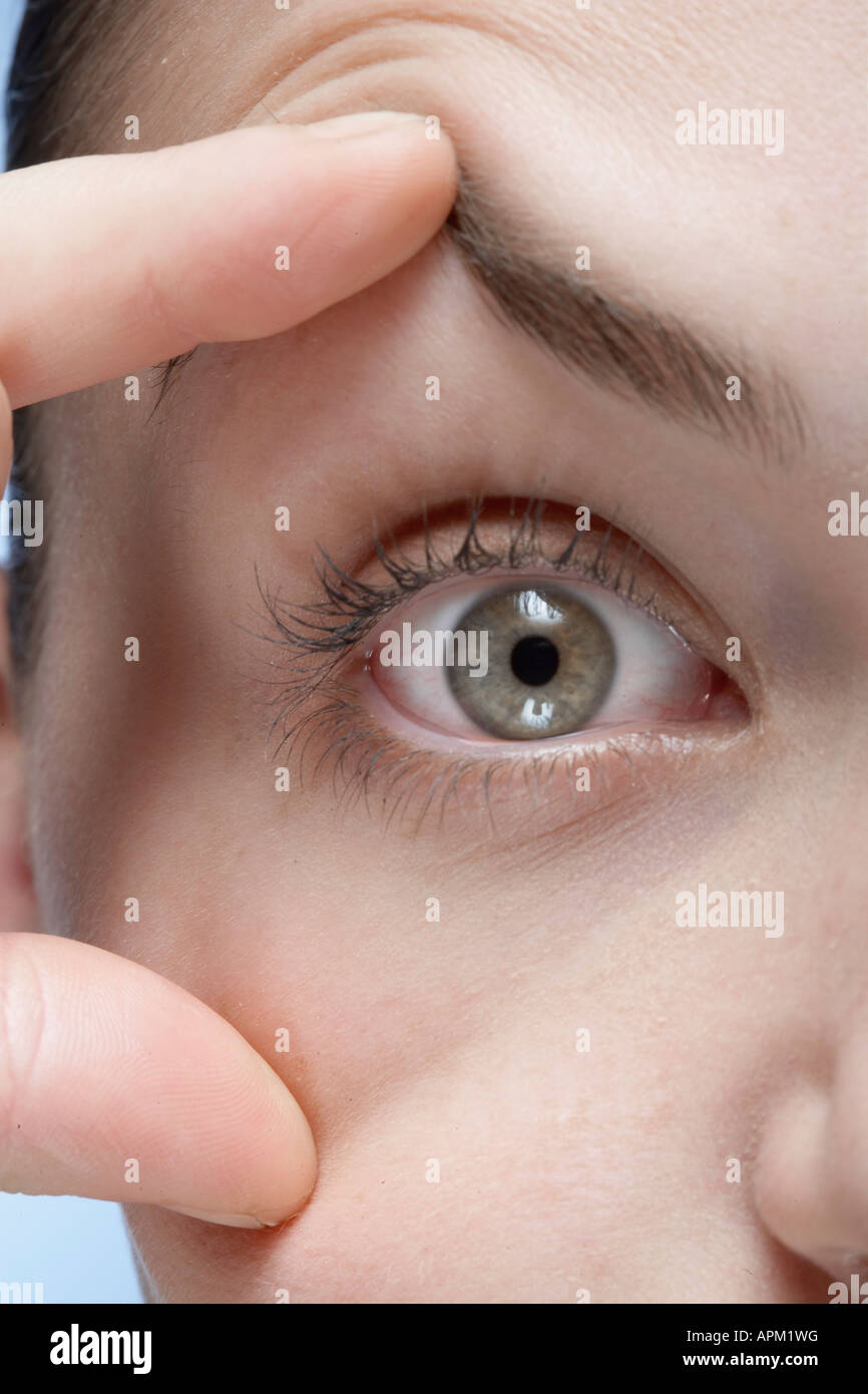 Woman holding her eye open, closeup Stock Photo Alamy