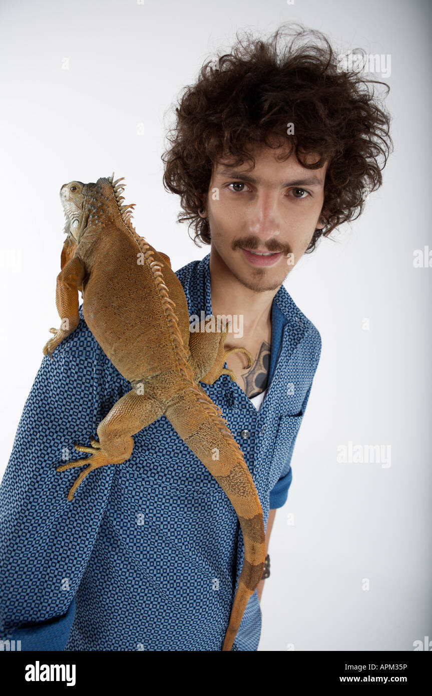 Man with Iguana Stock Photo