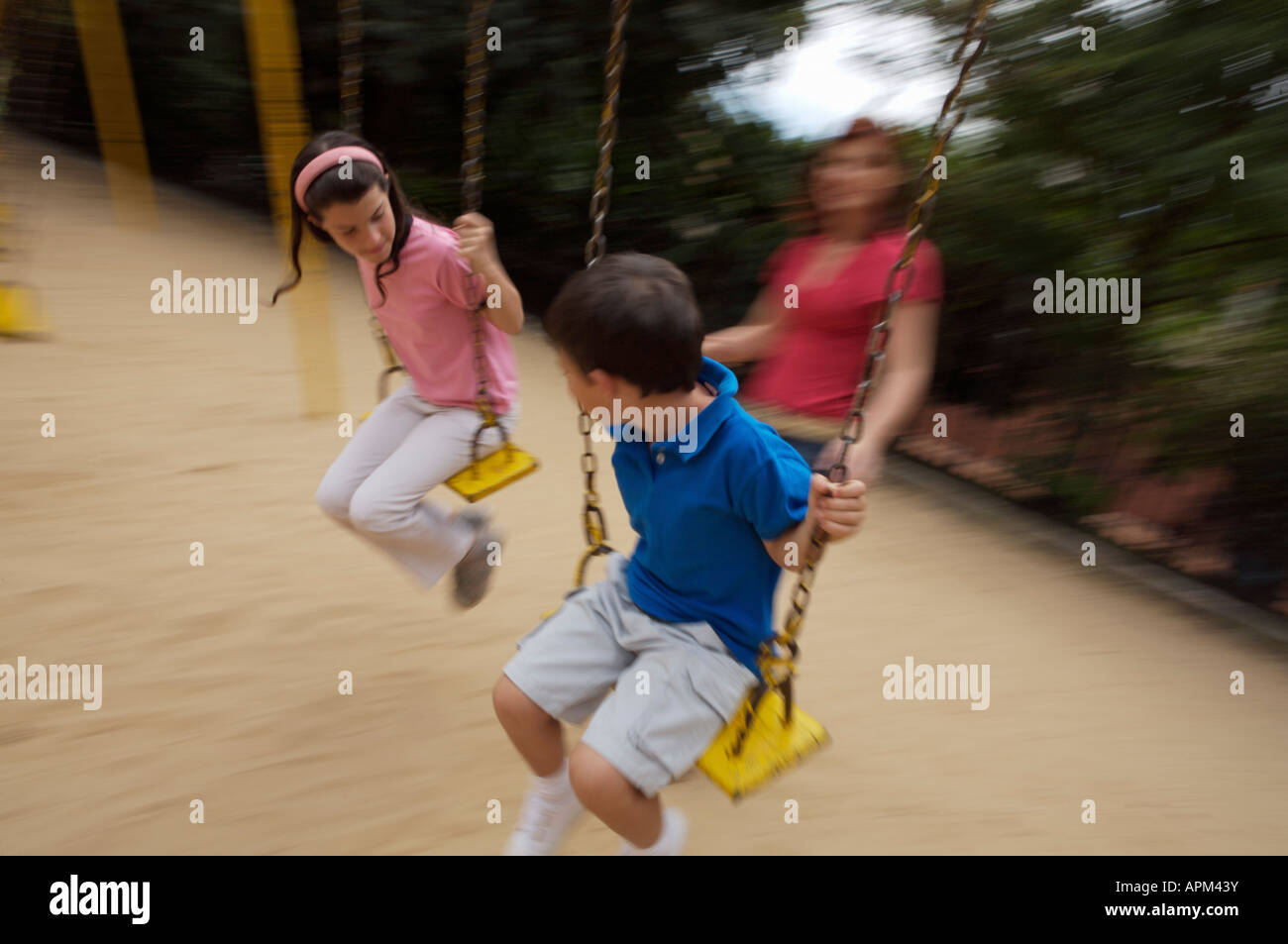 Mother and children in playground Stock Photo