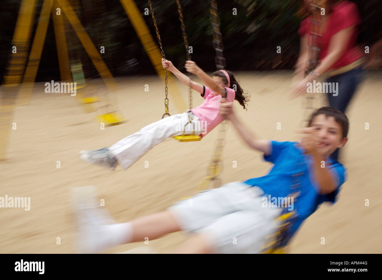 Mother and children in playground Stock Photo