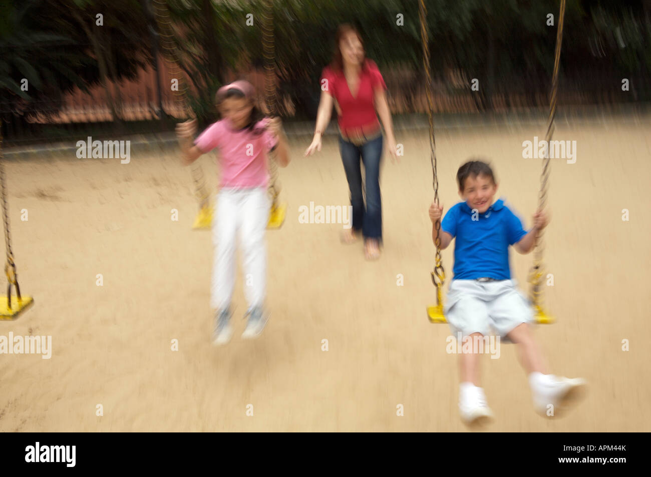 Mother and children in playground Stock Photo