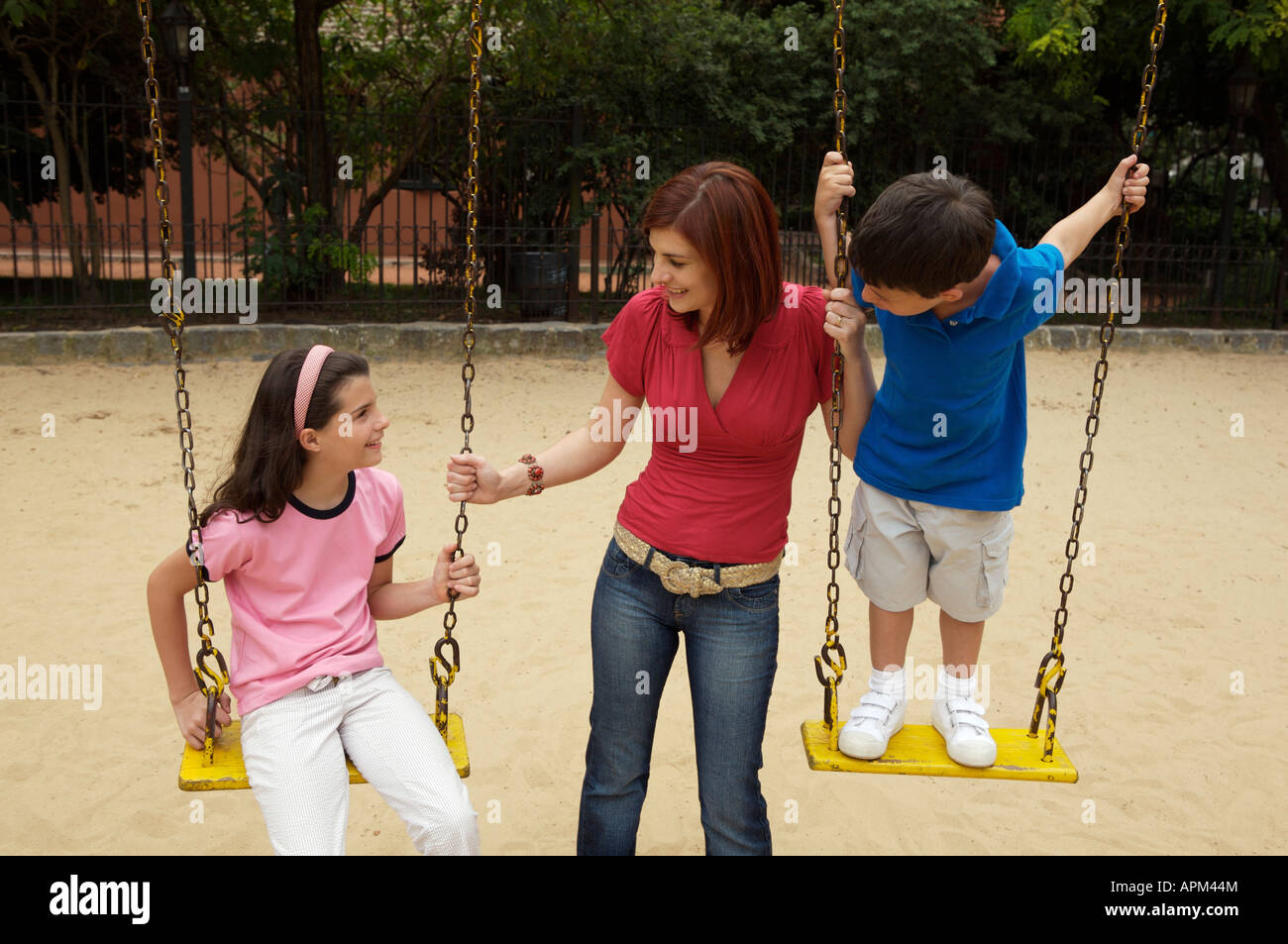 Mother and children in playground Stock Photo