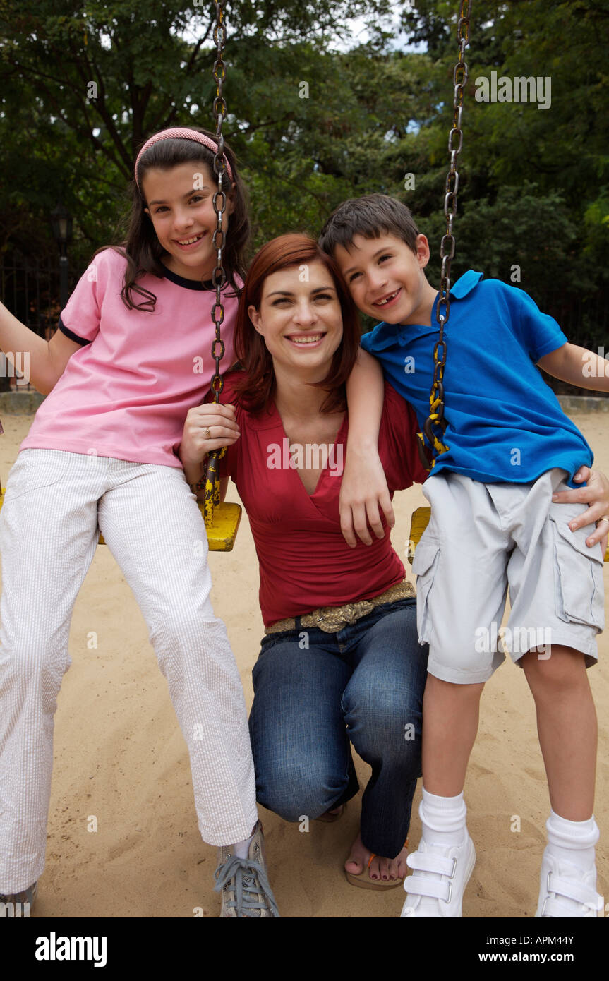 Mother and children in playground Stock Photo