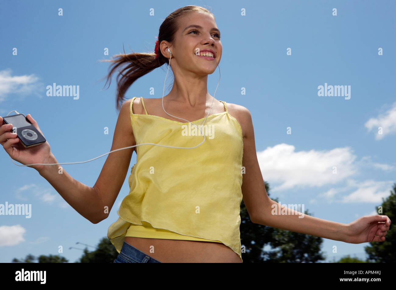 Teenage girl dancing in a park Stock Photo