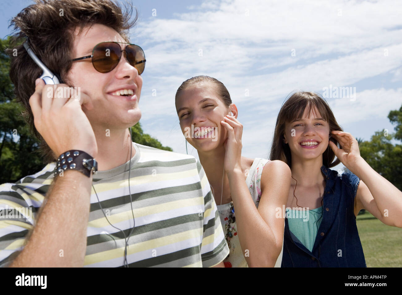 Teenagers listening to music in a park Stock Photo - Alamy