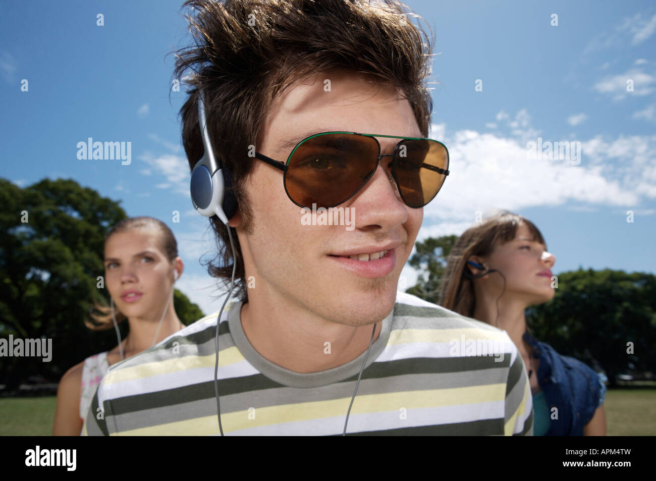 Teenagers listening to music in a park Stock Photo - Alamy