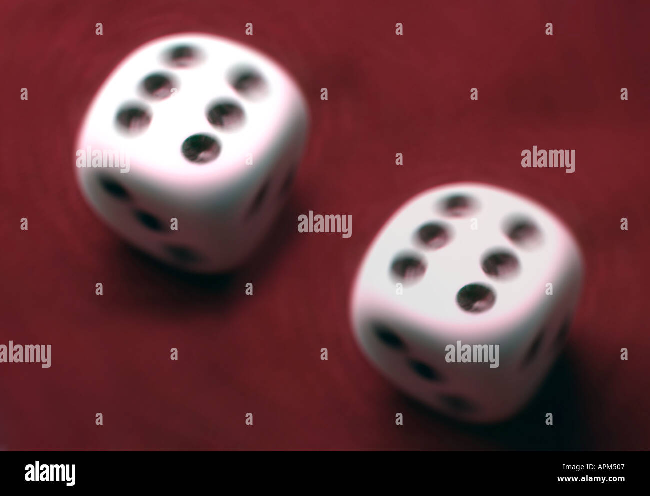 Semi abstract image of two white dice on red background with six